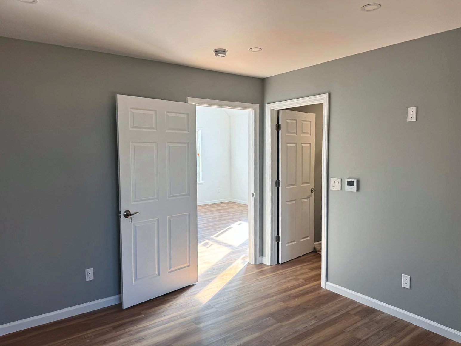 Gray bedroom with new six-panel doors and trim