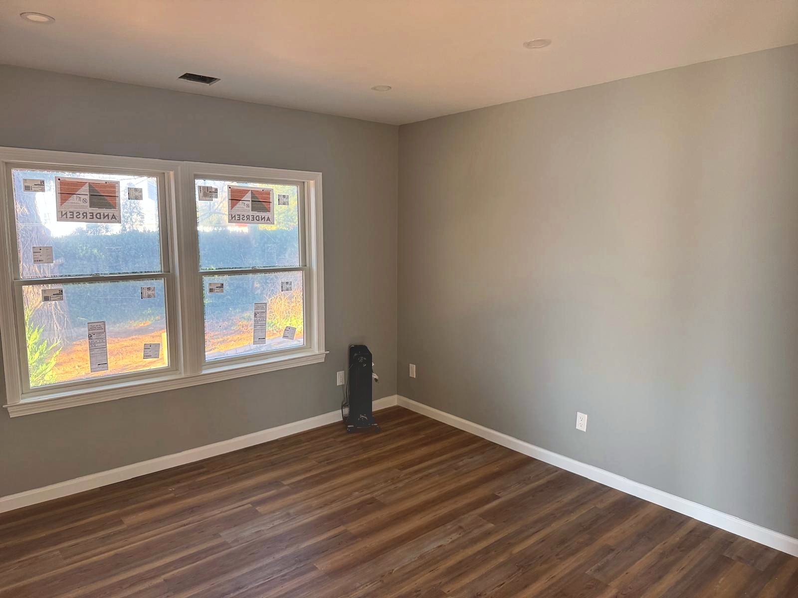Bedroom painted gray with new double-hung windows