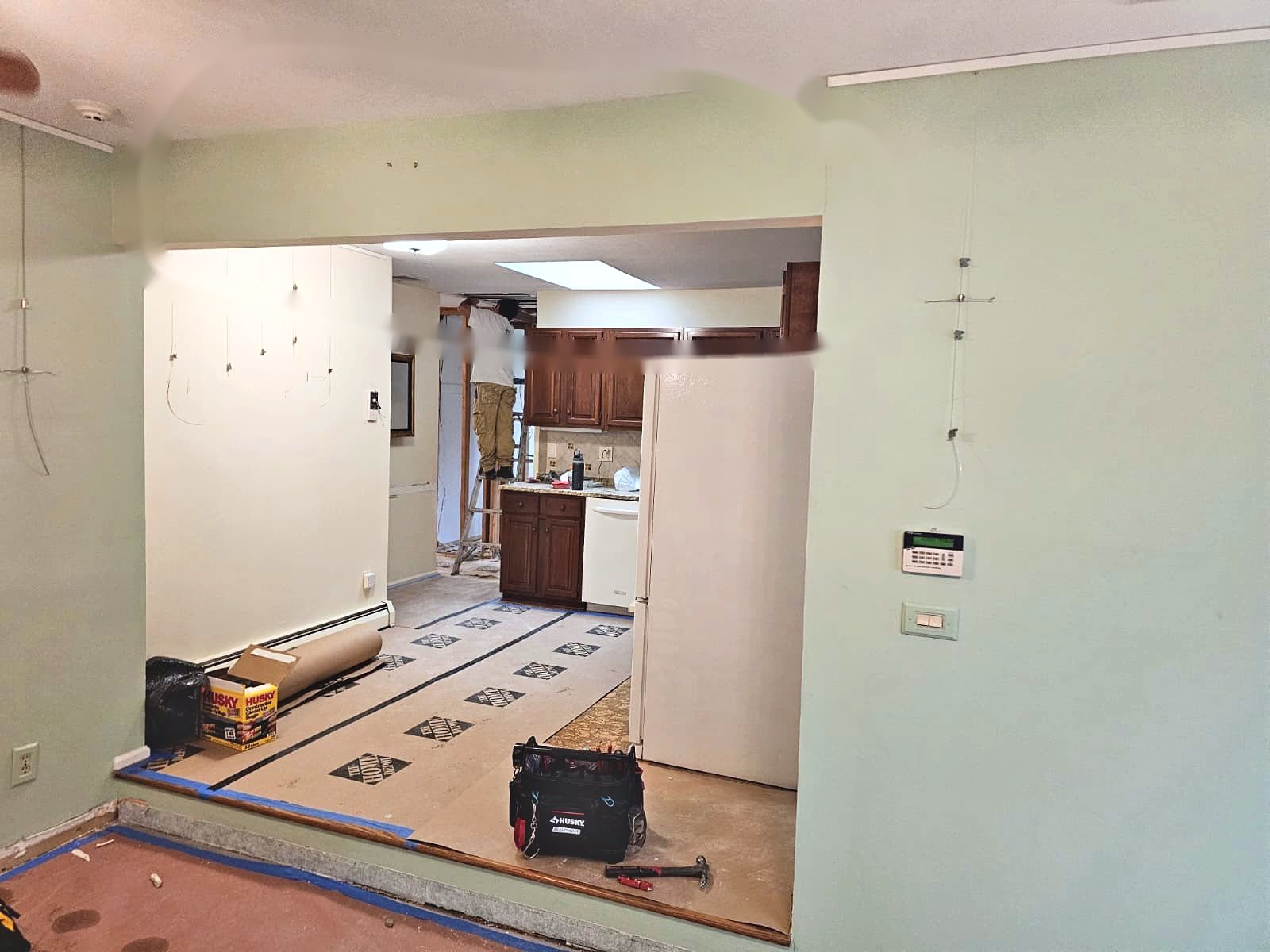 Wall between the living room and kitchen before removal