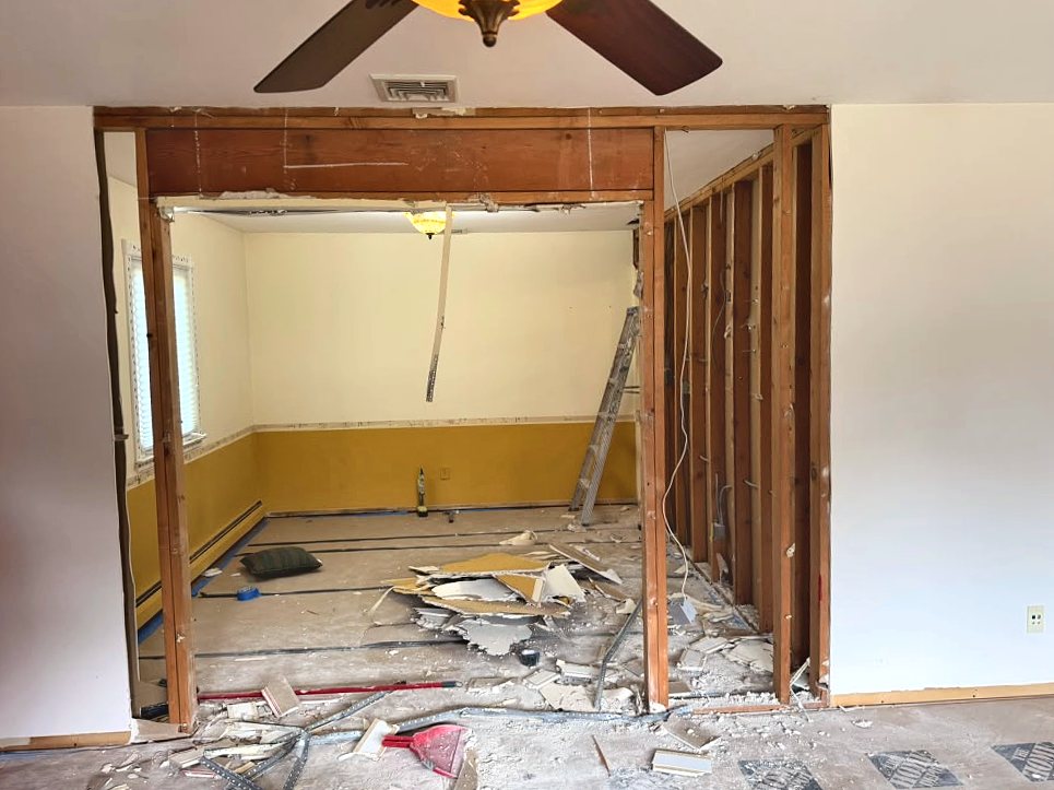 Wide opening framed between dining room and living room