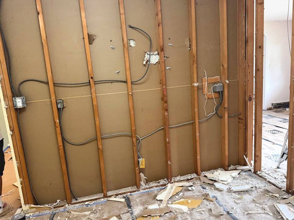 Wall stripped to studs with wiring exposed